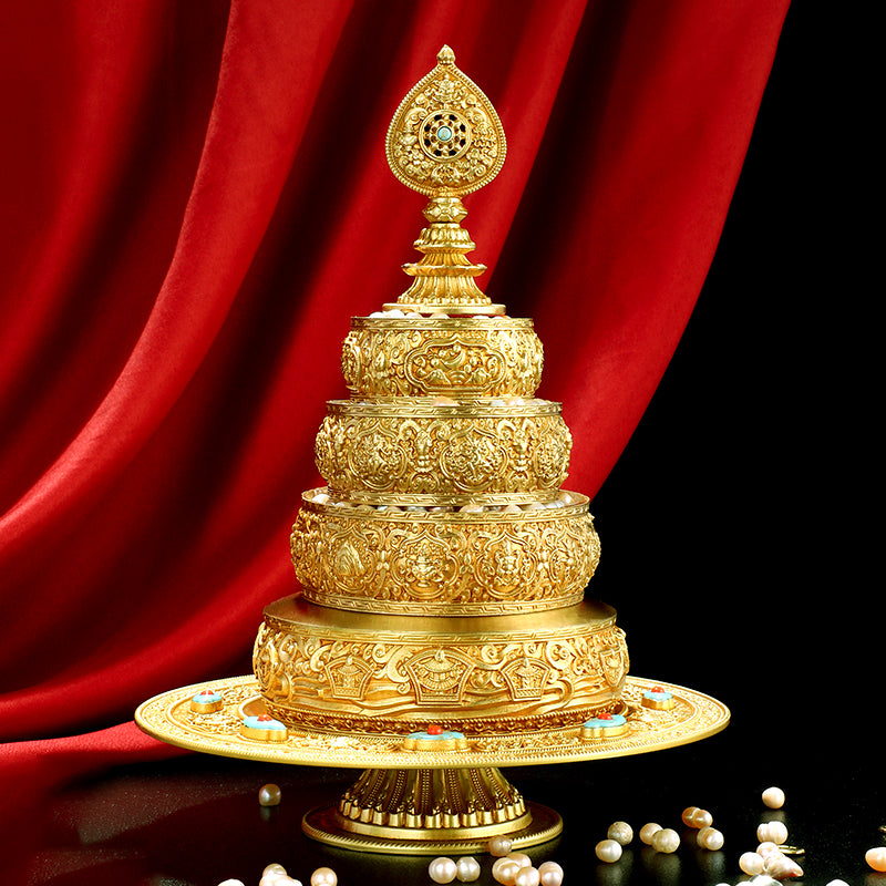 A golden brass Tibetan Buddhist mandala offering set with a stand, featuring intricate carvings and adorned with turquoise and other semi-precious stones.